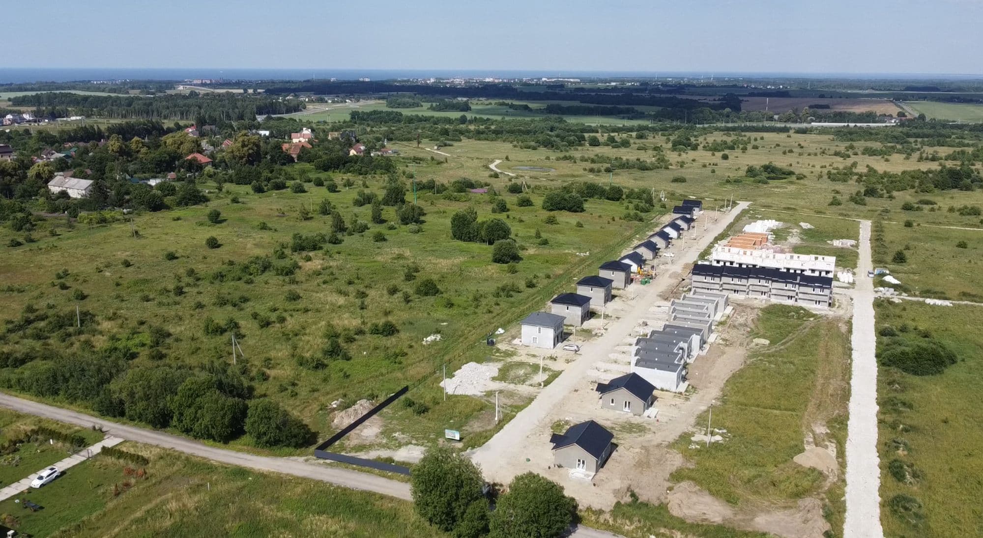 Посёлок Парк Лоренс с высоты: улицы, дома, поля и море на горизонте